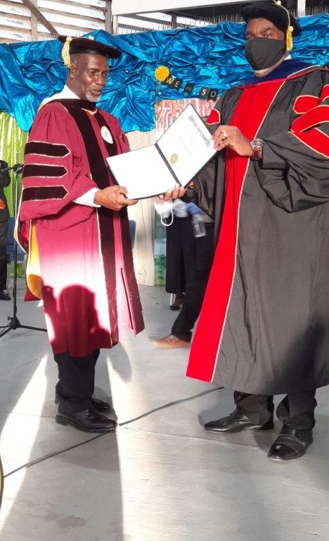 Diploma presentation by Pastor Dr. Carl Dyal to Dr. Byer